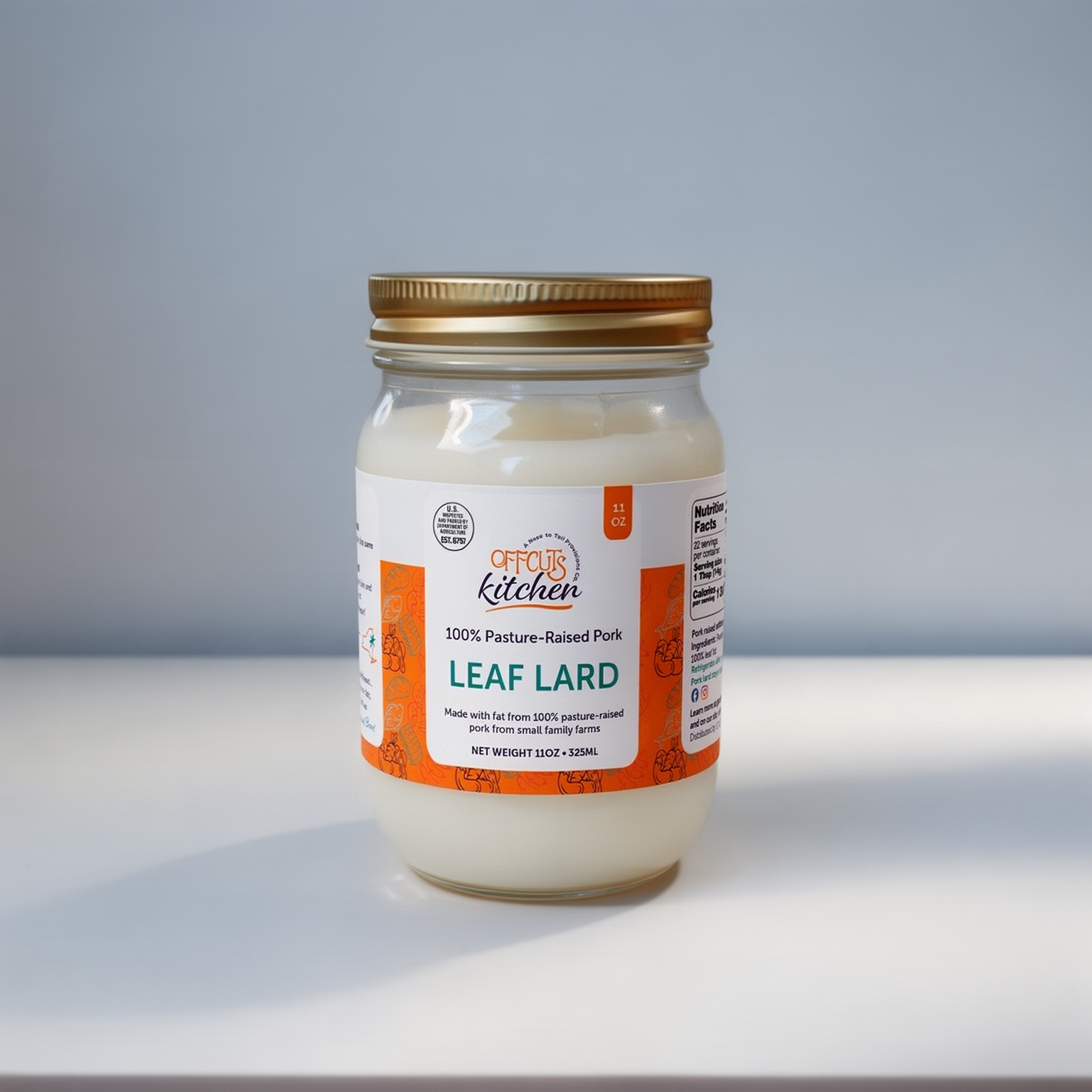 Jar of Leaf Lard with a gold lid on a light gray background