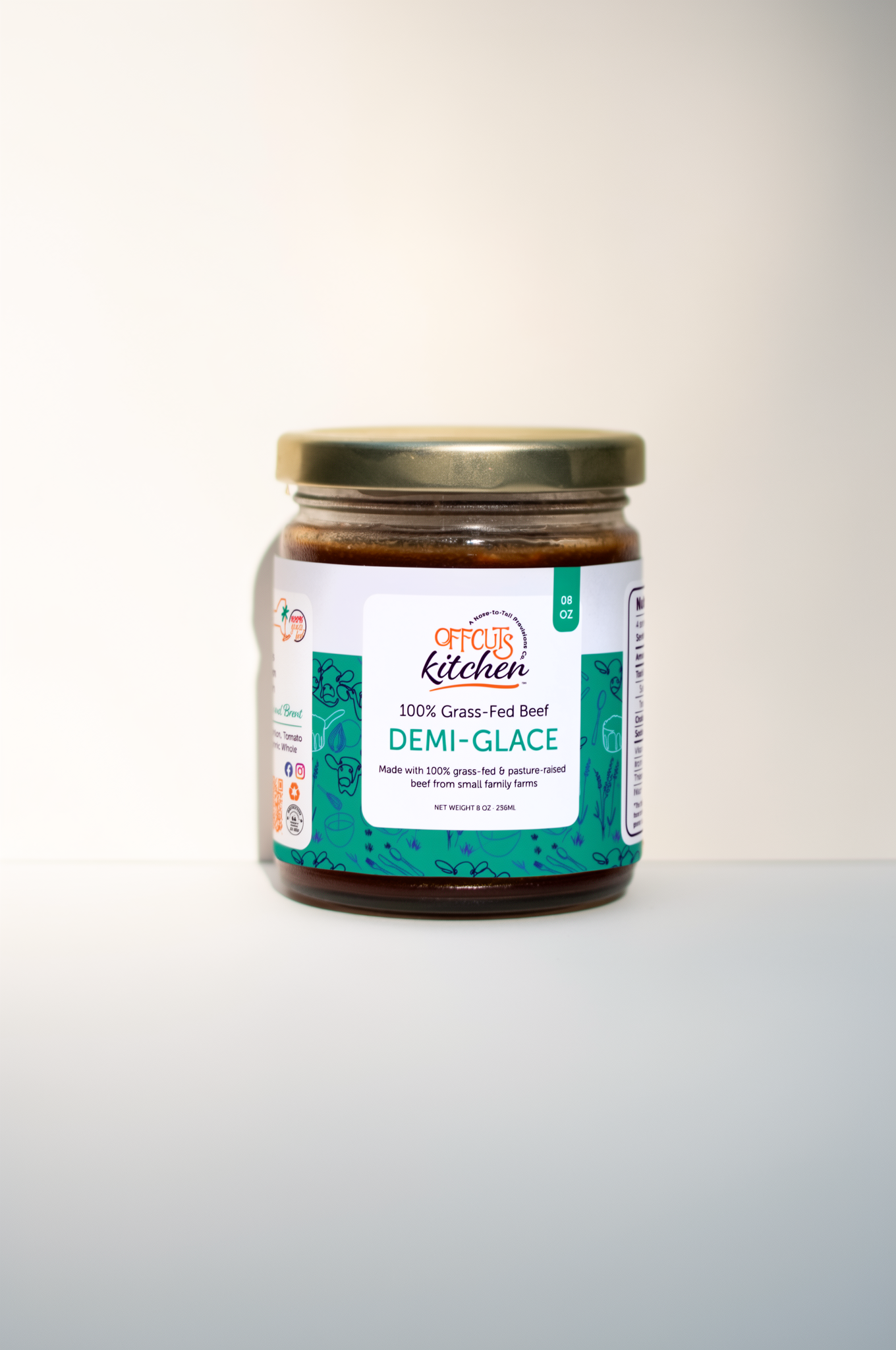 Jar of demi-glace sauce with a label on a white background