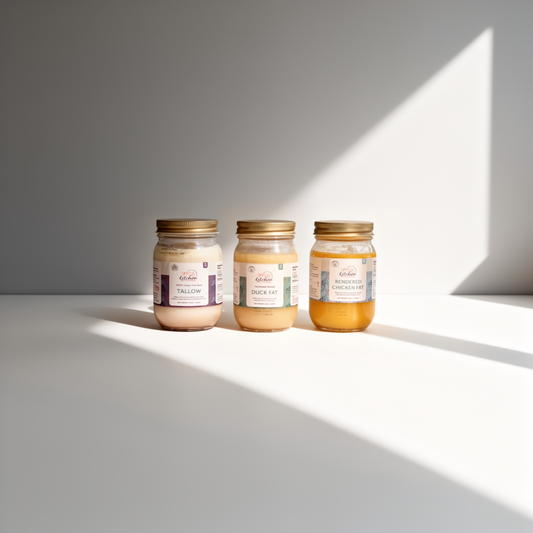 Three jars of different types of fat on a light surface with a soft shadow