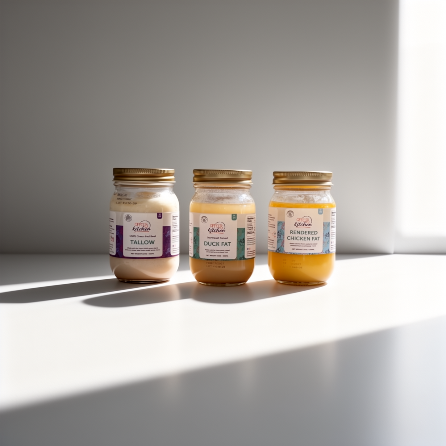 Three jars of different fats on a light surface with a neutral background